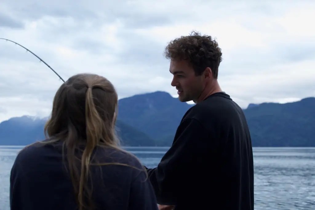 Justin showing a guest his fishing technique
