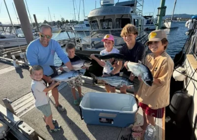 Family showing off their catch after a trip with Campbell River Fishing Guide